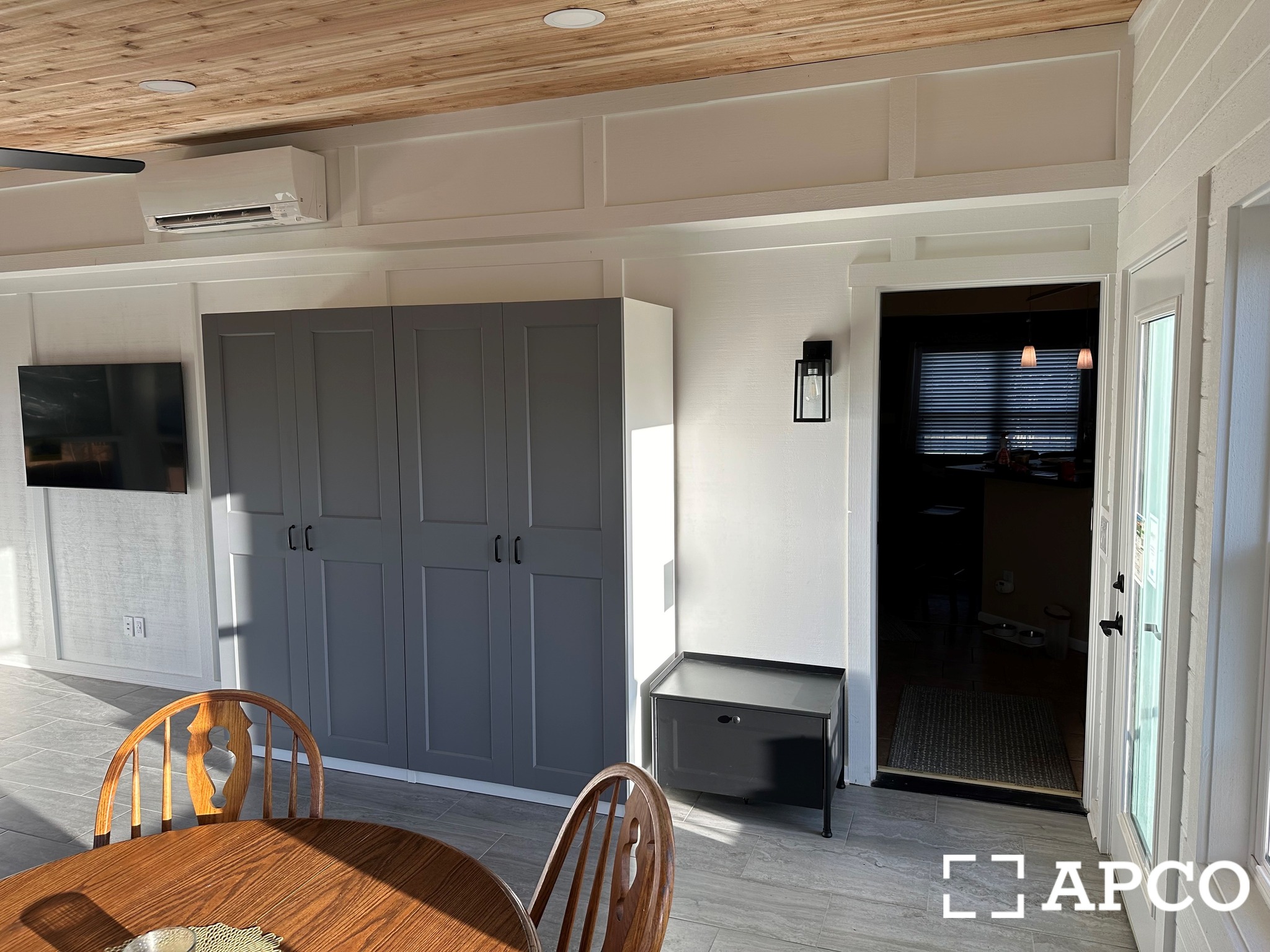 Finished sunroom interior with natural wood ceiling