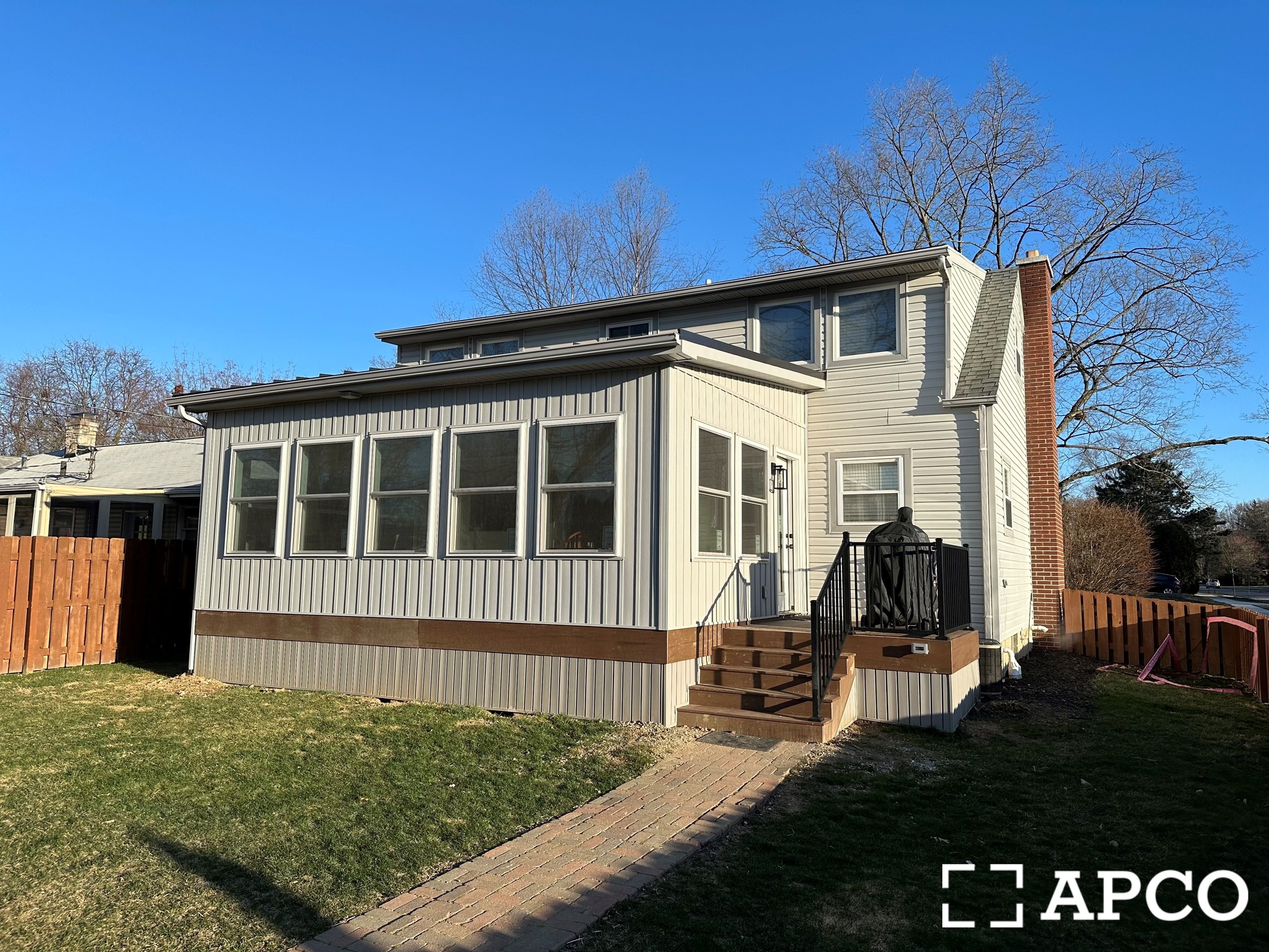 Home exterior with new siding and sunroom addition
