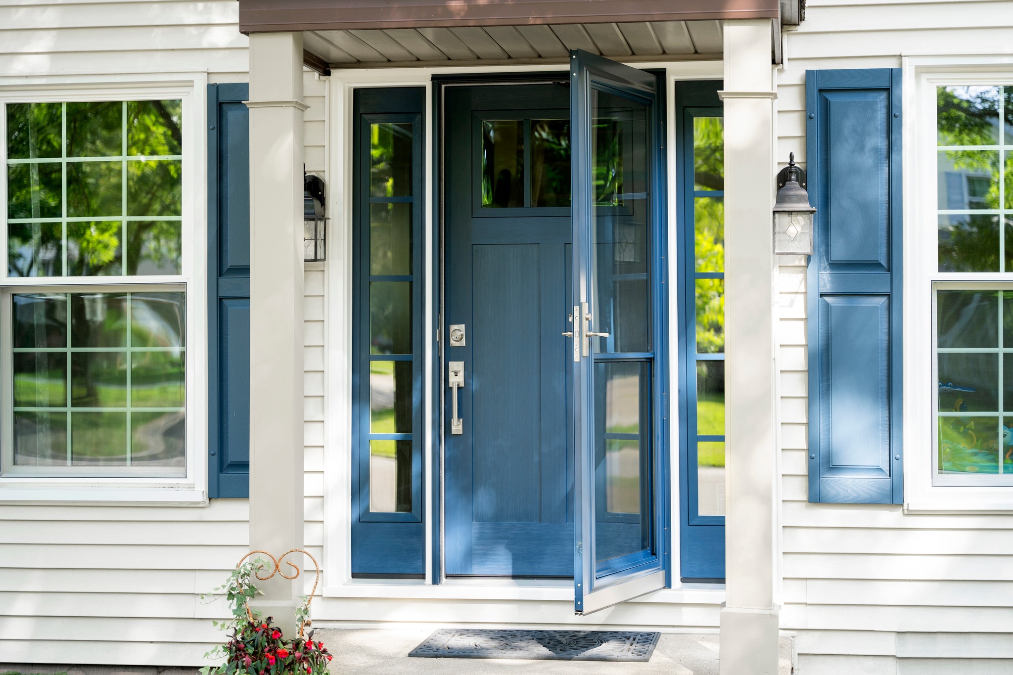 Front entry with blue door and matching shutters